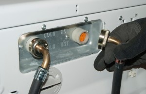 PHOTO: Reconnect the fill hoses to the inlet valve.