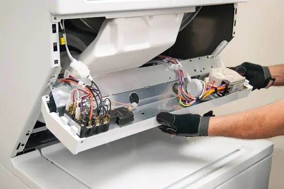 PHOTO: Release the control panel from the laundry center frame.