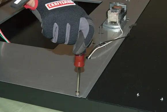 PHOTO: Reinstall the cover screws.