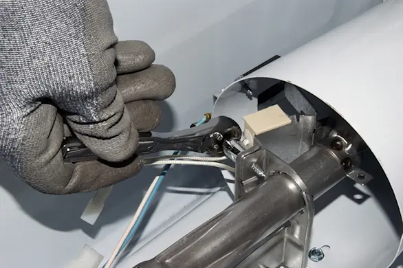 PHOTO: Remove the igniter mounting screws.