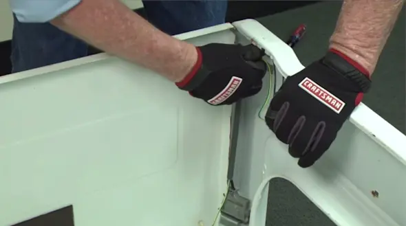 PHOTO: Remove the lid switch from the cabinet.