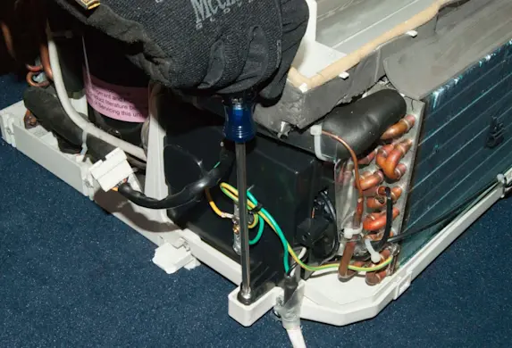 PHOTO: Remove the screws from the control board case.