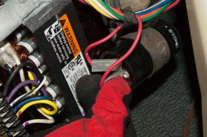 PHOTO: Reattach the drive motor capacitor wires.