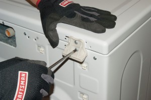 PHOTO: Remove the top panel screws at the back of the washer.