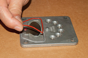 Install the new upper valve plate seal.