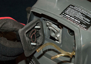 Remove the carburetor adapter and air dam.