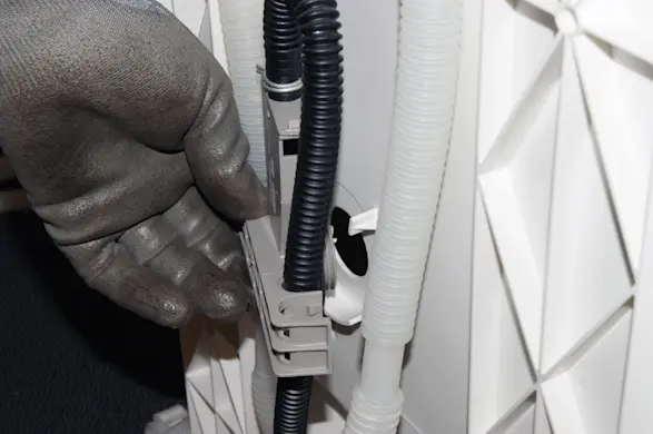 PHOTO: Release the drain hose from the water inlet.