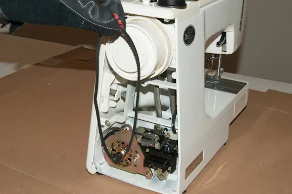 PHOTO: Slide the belt off the hand wheel and remove.