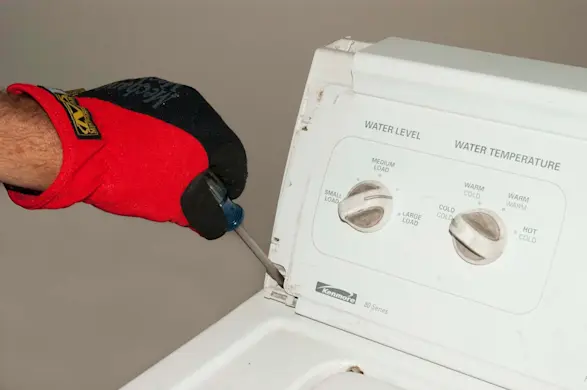 PHOTO: Remove the screws at the base of the control panel console.