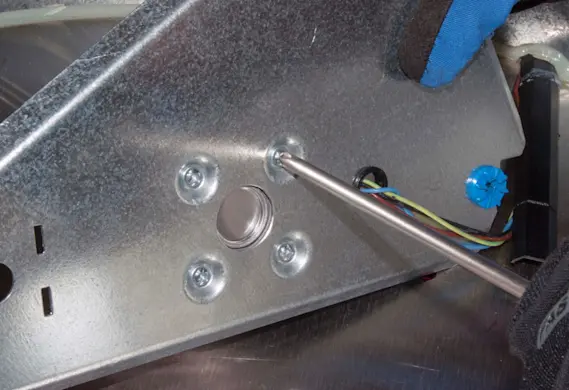 PHOTO: Attach the new fan motor to the mounting plate.