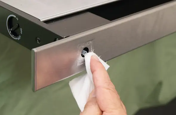 PHOTO: Clean the button pad mounting surface.
