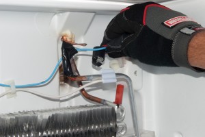PHOTO: Clip the new defrost bi-metal thermostat in place.