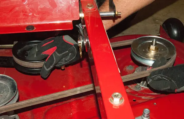PHOTO: Roll the blade belt off of the pulley.
