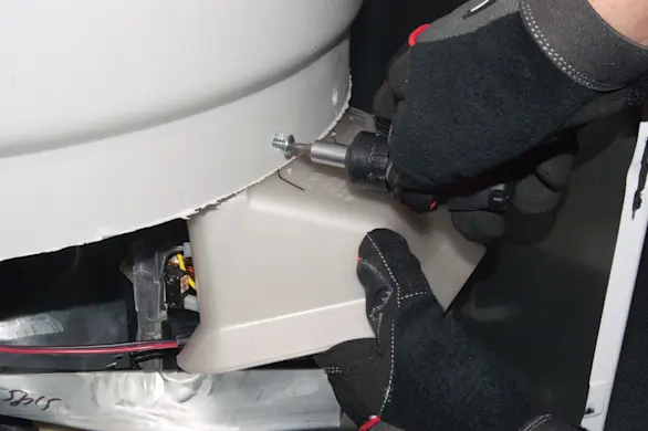 PHOTO: Remove the motor shield screws.