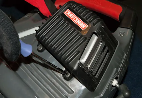 PHOTO: Remove the muffler guard cover screws.