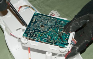 PHOTO: Release the circuit board from its housing.