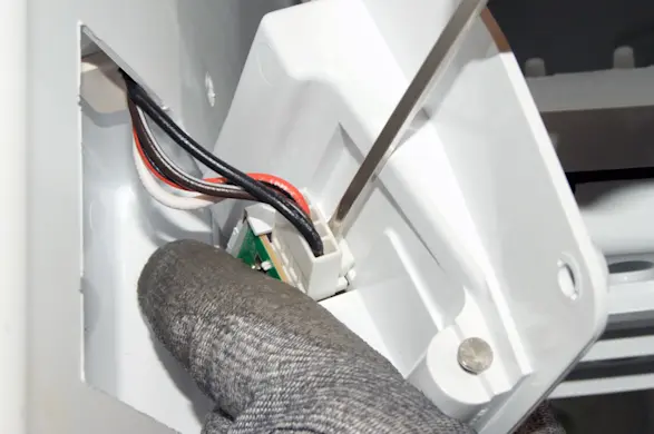 PHOTO: Release the wire harness locking tab.