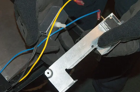 PHOTO: Remove the switch and bracket assembly.