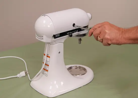 PHOTO: Remove the motor brush caps.