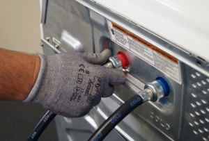 PHOTO: Disconnect the hoses from the back of the washer.