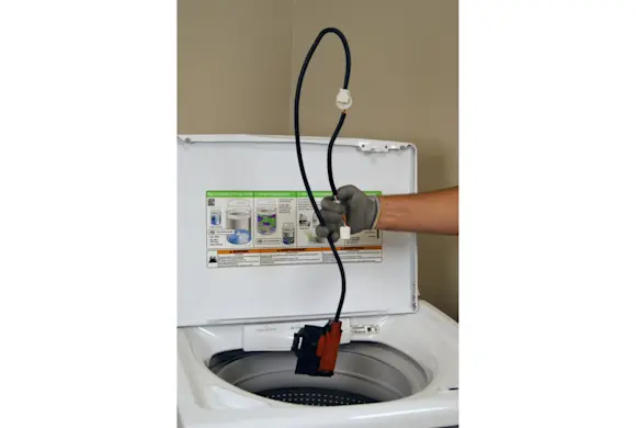 PHOTO: Pull the lid switch/lock assembly out of the washer.