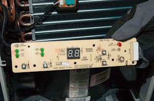 Lift the user interface control board out of the grille.