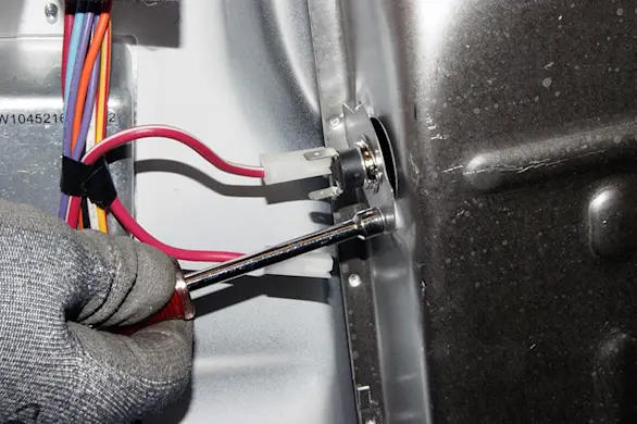 PHOTO: Remove the mounting screws from the thermal cut-off fuse.