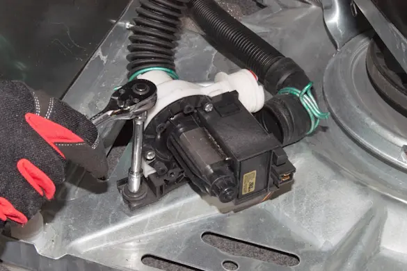 PHOTO: Remove the washer drain pump mounting screws.