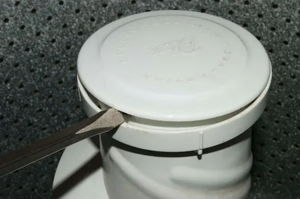 PHOTO: Pry off the agitator cap.