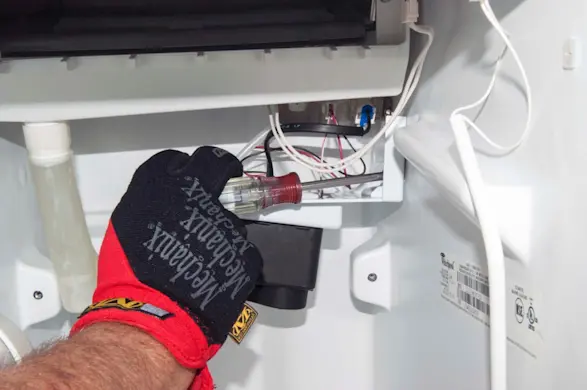 PHOTO: Remove the recirculation pump bracket mounting screws.