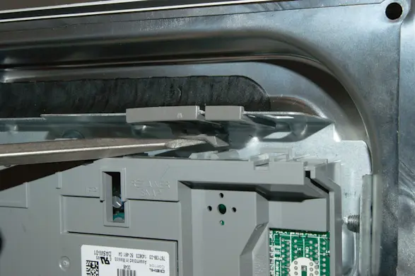 PHOTO: Release the locking tab on the control board.
