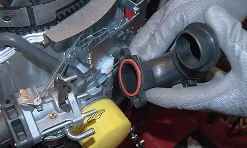 PHOTO: Install the new carburetor.