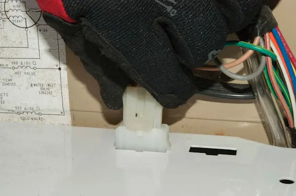 PHOTO: Plug in the lid switch wire harness.
