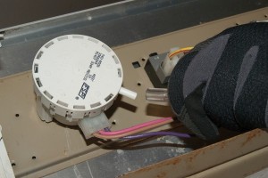 PHOTO: Disconnect the air hose from the water level pressure switch.