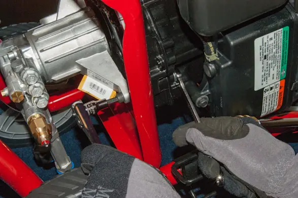 PHOTO: Loosen the pump mounting bolts.