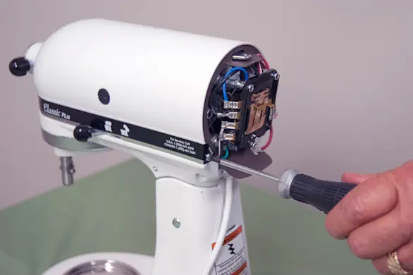 Reinstall the trim band screws.