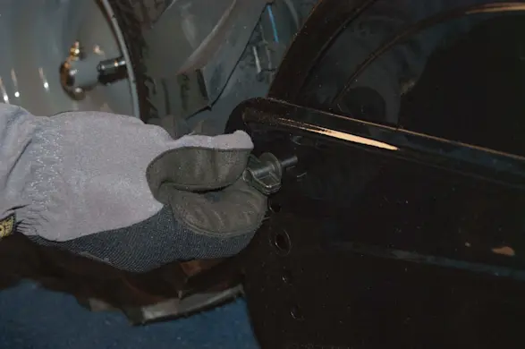 PHOTO: Remove the side shield wing nuts.