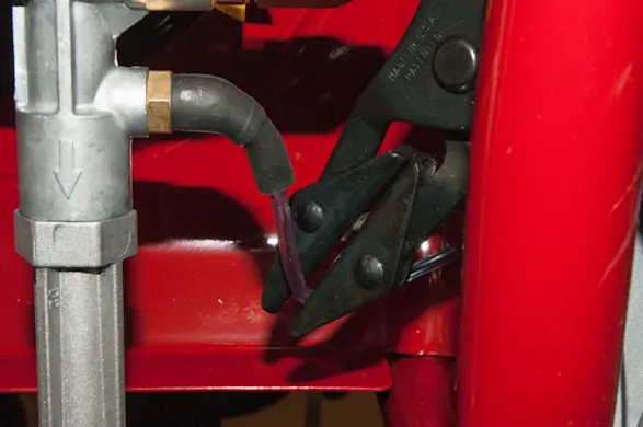 PHOTO: Clamp off the chemical injection hose.