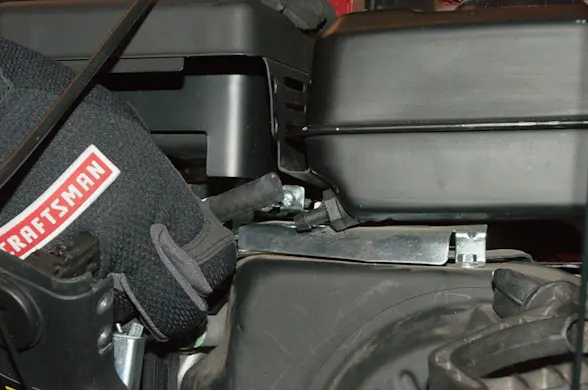 PHOTO: Connect the new fuel line on the tank and secure it with the clamp.