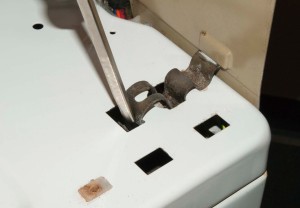 PHOTO: Insert a screwdriver to pry the clips forward.