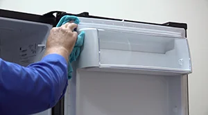 PHOTO: Clean the outside edge of the refrigerator door.
