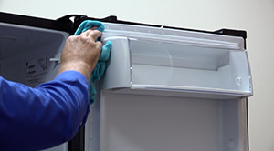 PHOTO: Clean the outside edge of the refrigerator door.