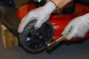 Remove the nut that holds the wheel to the axle shaft.