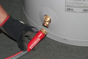 PHOTO: Attach the garden hose the water heater heater drain valve.
