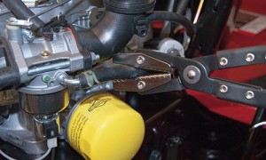 PHOTO: Clamp off the fuel line with hose pinch-off pliers.