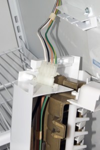 PHOTO: Remove the ice maker from the rails to access the wire harness.