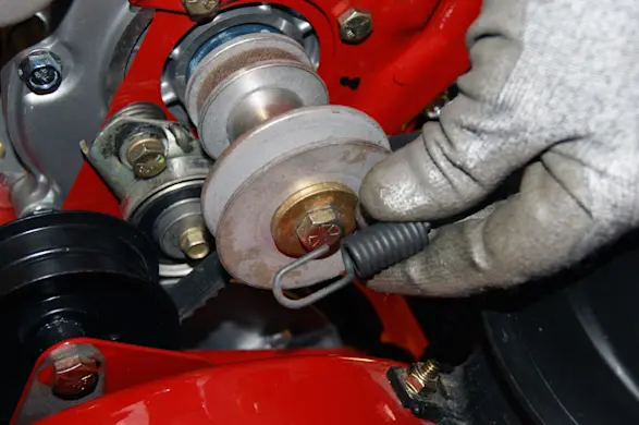 PHOTO: Unhook the cable from the idler pulley.