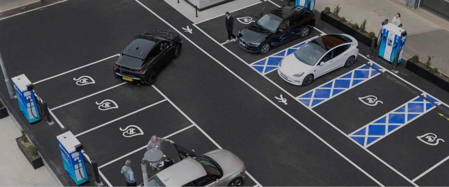 Woman charging electric vehicle