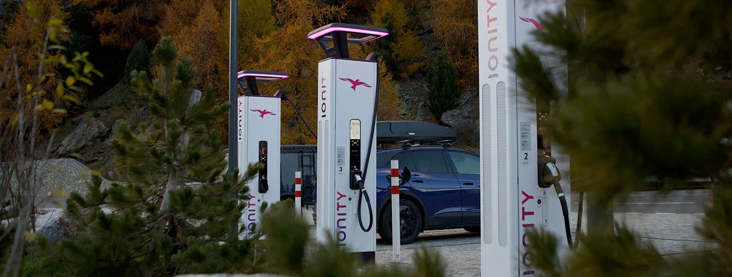 Woman charging electric vehicle