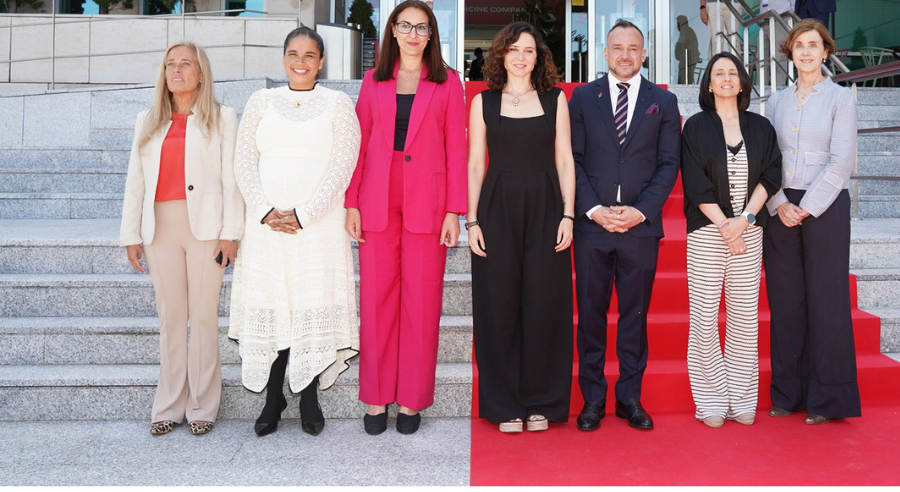 Imagen de 6 personas en la puerta del Centro de I+D de Lilly:  En el medio la presidenta de la Comunidad de Madrid, a su derecha la alcaldesa de Alcobendas en funciones, a la derecha de ésta la presidenta de Lilly España y seguidamente la consejera de Economía. Por el otro lado, al a izquierda de la presidenta de la Comunidad el vicepresidente ejecutivo de operaciones globales de fabricación de Lilly, a su lado la secretaria de Estado de Economía y a su derecha la directora de Asuntos Corporativos de Lilly